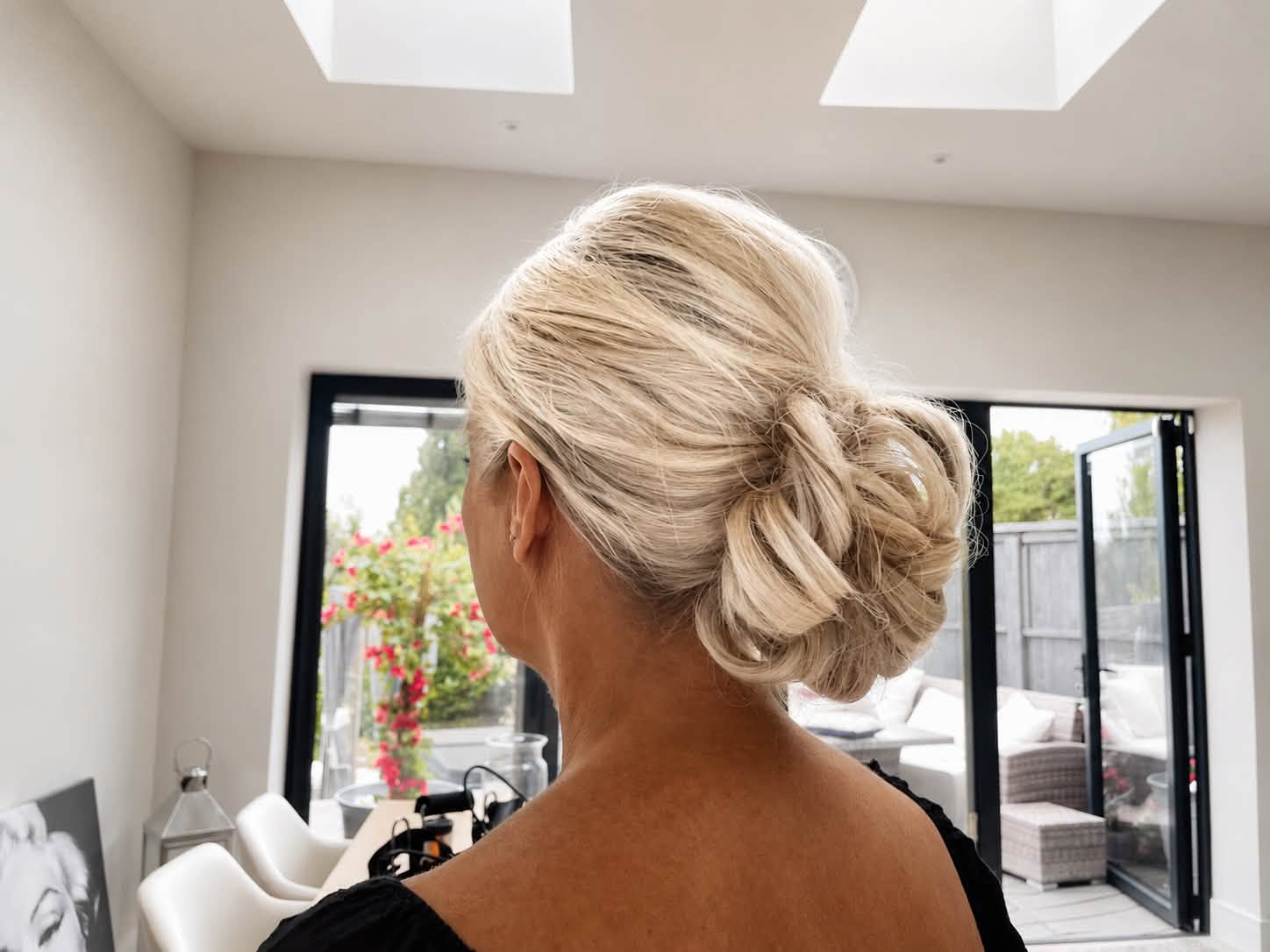 Textured blonde low updo, side view