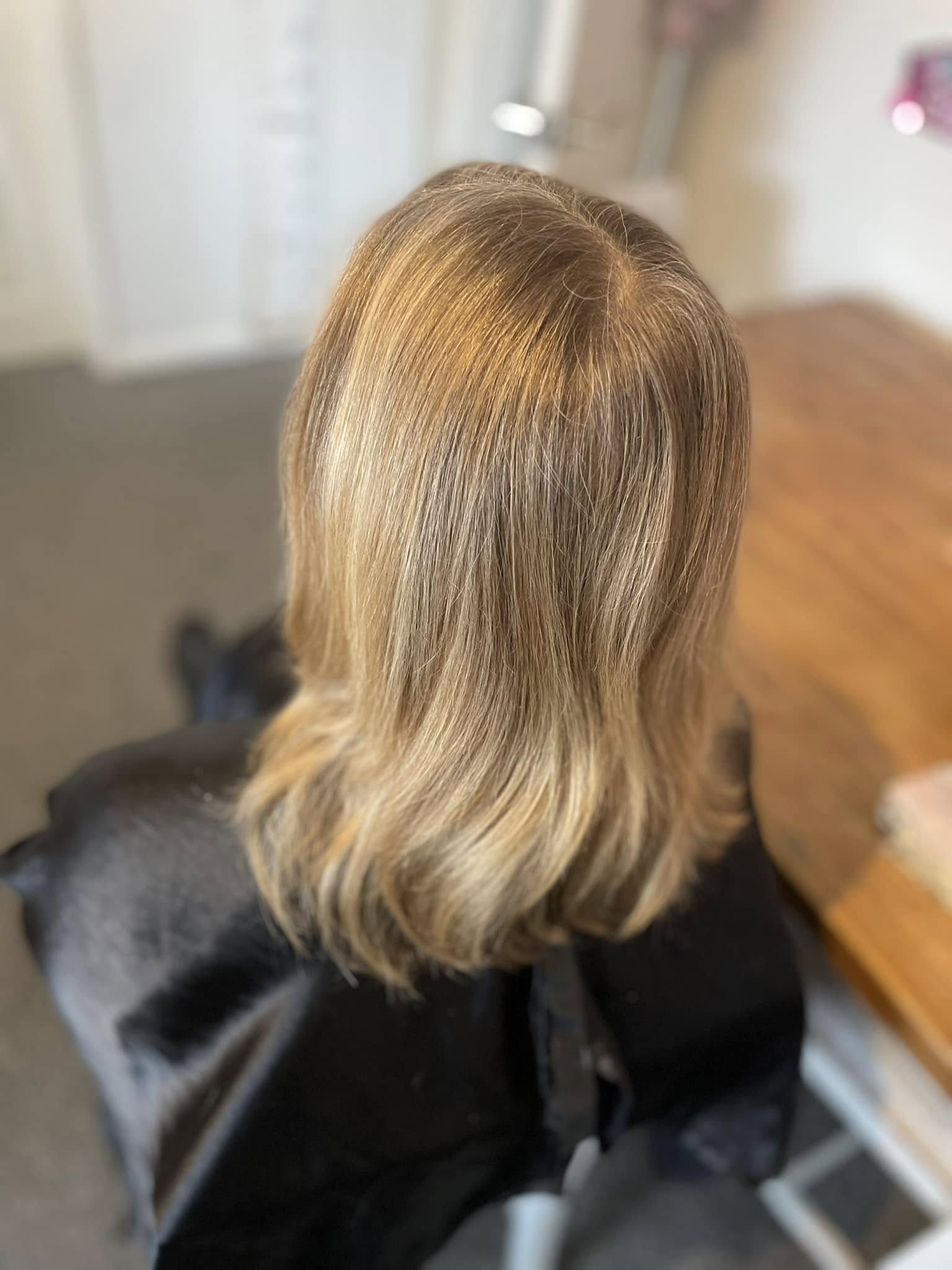Shoulder-length blonde hair with softly curved ends