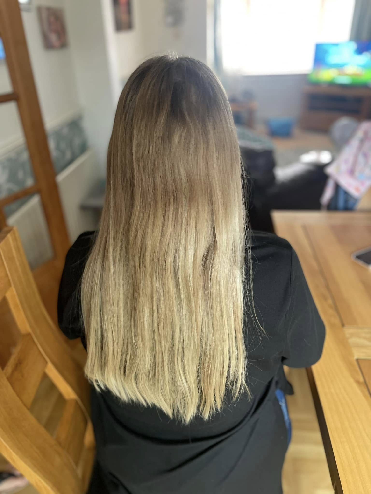 Long straight blonde hair with darker roots